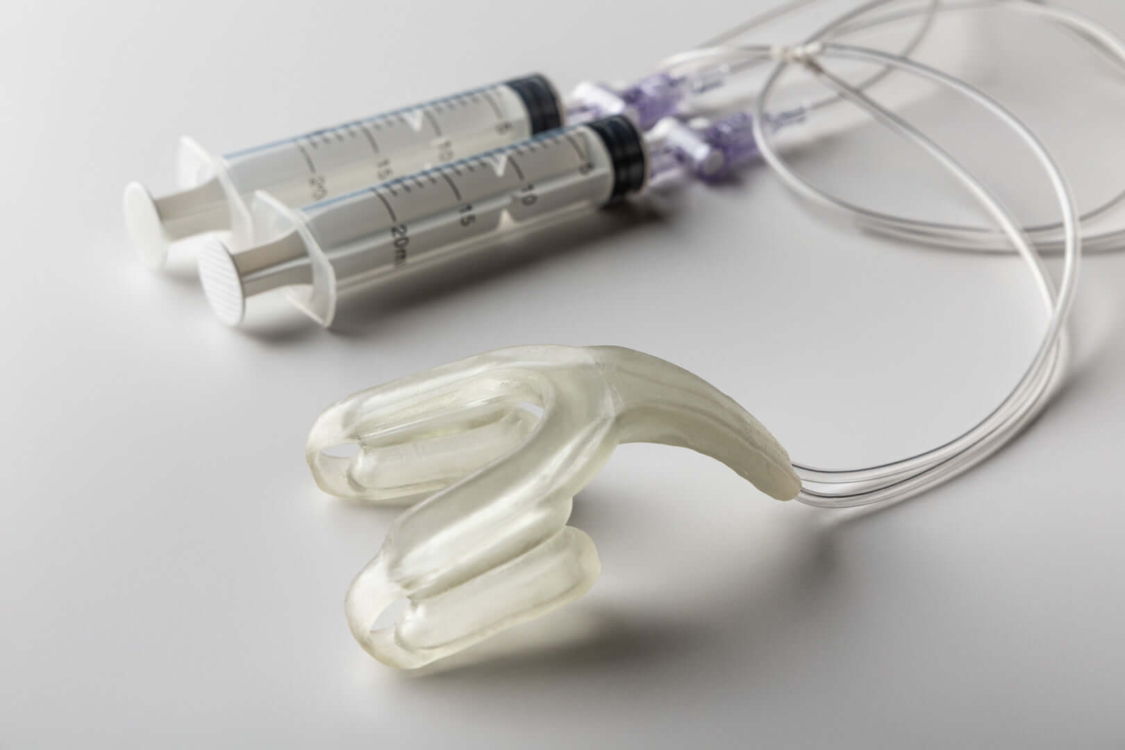 Isences® TMD Physio Care™ jaw mobility exercise device with syringes for rehabilitation and controlled movement.